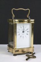 A French made gilt brass cased carriage clock with bevelled glass panels, complete with key.