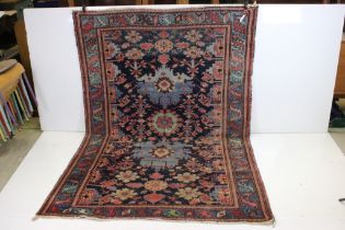 Eastern Wool Blue ground Rug with stylised floral pattern within a border, 138cm x 192cm