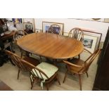 Ercol Oval Extending Dining Table, 165cm long x 107cm wide x 75cm high together with a set of Six