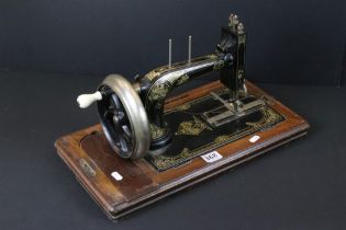 German early 20th Century Dietrich sewing machine having a hand crank wheel with gilt floral