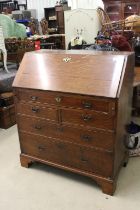 George III Oak Bureau, the fall front opening to a fitted interior, over two short and three long