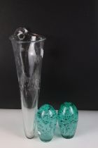 Two control bubble end of day glass paperweights together with a clear art glass vessel with control