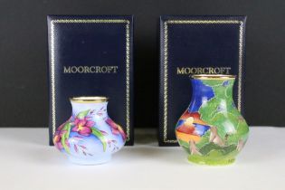 Two miniature Moorcroft vases with enamel decoration, both within fitted display boxes.