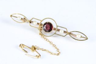 An early 20th century Art Nouveau 15ct gold bar brooch with amethyst and seed pearl decoration.