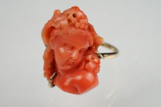 19th century coral 9ct yellow gold ring, the carved coral depicting a female head with grapes and