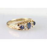 Edwardian 18ct gold diamond and sapphire ring set with a central oval cut sapphire flanked by two