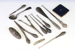 Silver handled items to include two pairs of glove stretchers, a shoe horn, four button hooks, Irish