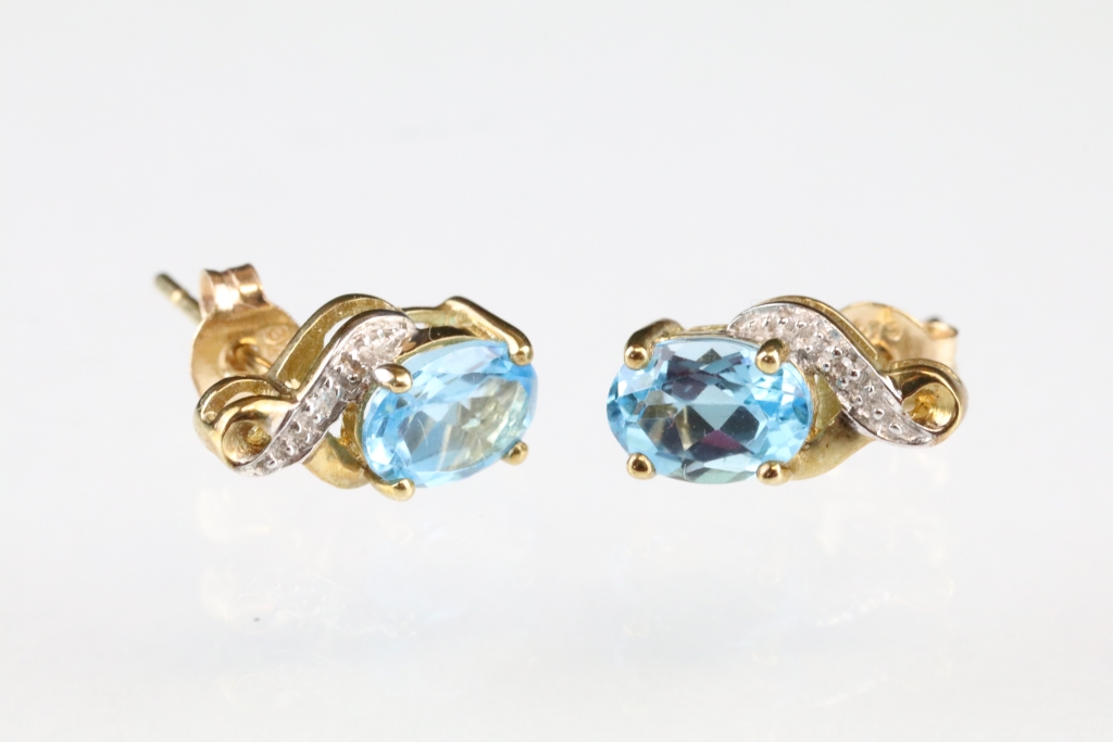 Pair of topaz and diamond 9ct yellow and white gold set stud earrings, the oval mixed cut blue topaz - Image 2 of 3