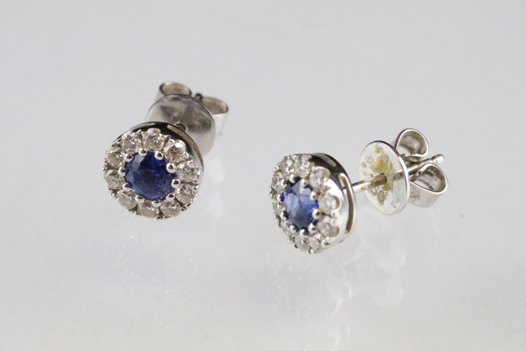 Pair of sapphire and diamond 18ct white gold cluster stud earrings, the round mixed cut sapphire