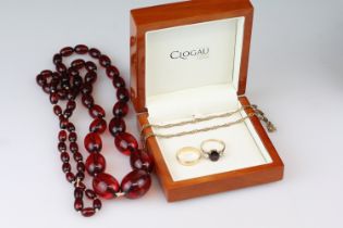 Garnet and white stone 9ct gold three stone ring, size Q½; a 9ct gold wedding band, size Q; together