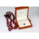 Garnet and white stone 9ct gold three stone ring, size Q½; a 9ct gold wedding band, size Q; together