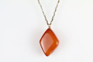 Butterscotch amber-style pendant, rose metal mount, the lozenge-shaped pendant dimensions approx 3.5