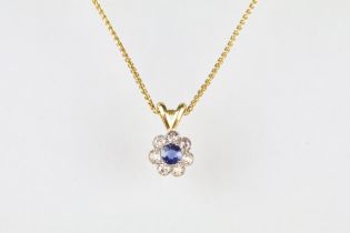 Sapphire and diamond 18ct yellow gold flower head pendant necklace, the round mixed cut sapphire