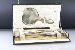 Silver backed dressing table brush set, comprising hand mirror, two hair brushes, two clothes