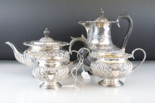 Late Victorian four piece silver tea service, comprising teapot, hot water pot, milk jug and sugar