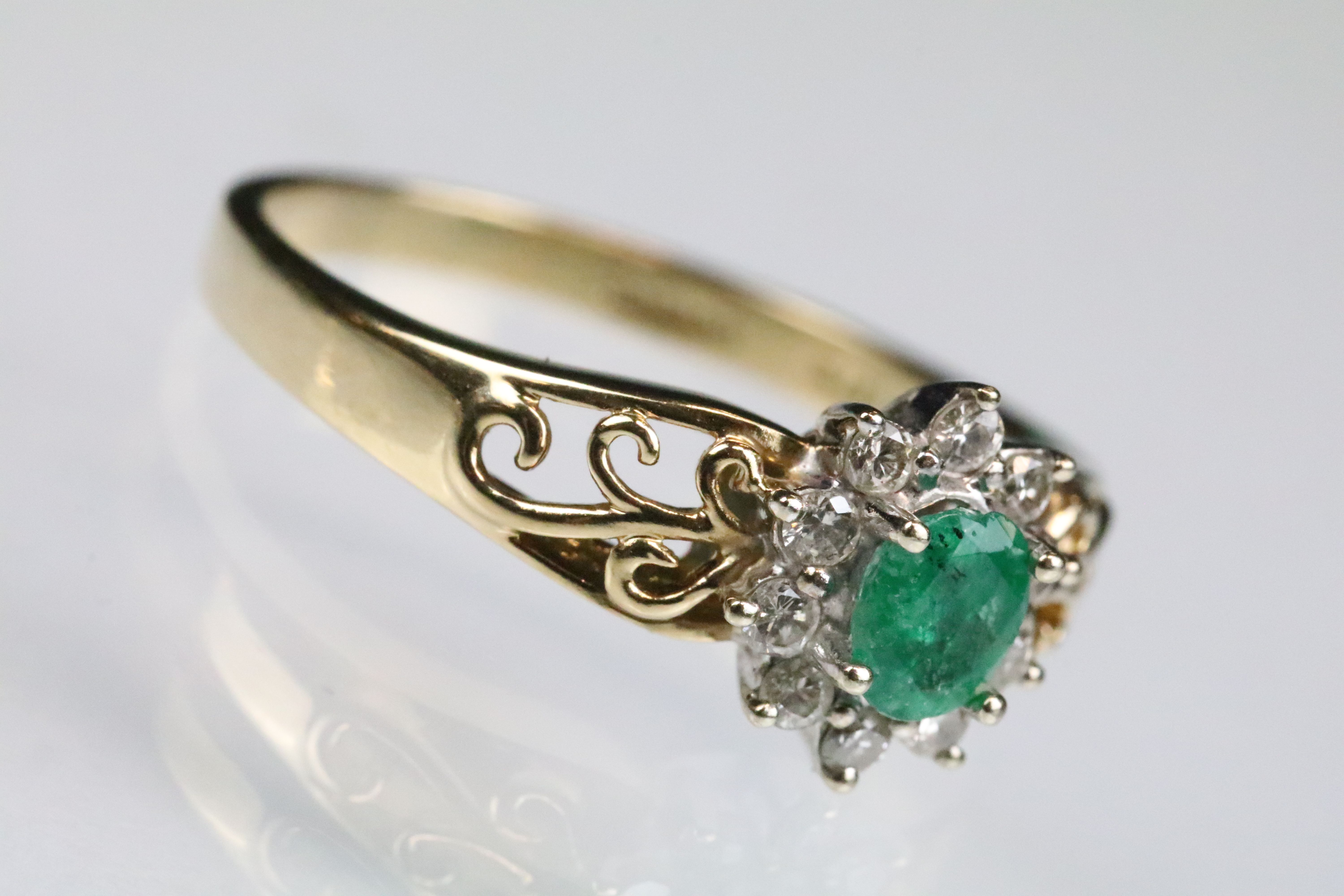 Emerald and diamond 9ct yellow and white gold flower head cluster ring, the oval mixed cut emerald - Image 3 of 6