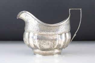 George III silver sauce boat, engraved foliate, fruit, swag & garland decoration, gilt lined