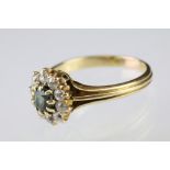 Green sapphire and diamond cluster ring, the oval mixed cut green sapphire measuring approx 5 x 4mm,