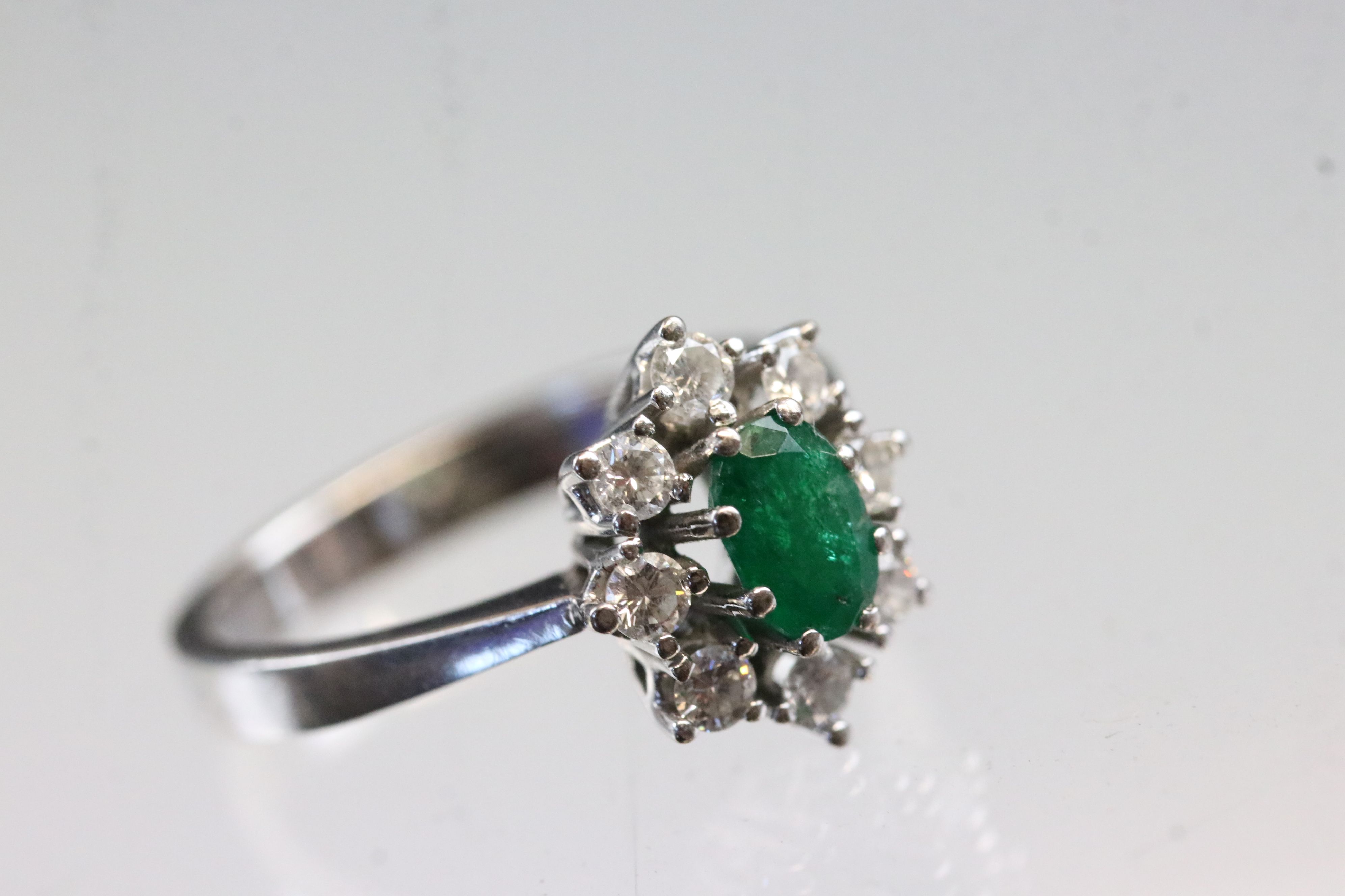 Emerald and diamond 18ct white gold cluster ring, oval mixed cut emerald, dimensions approx 6 x 4mm, - Image 5 of 5