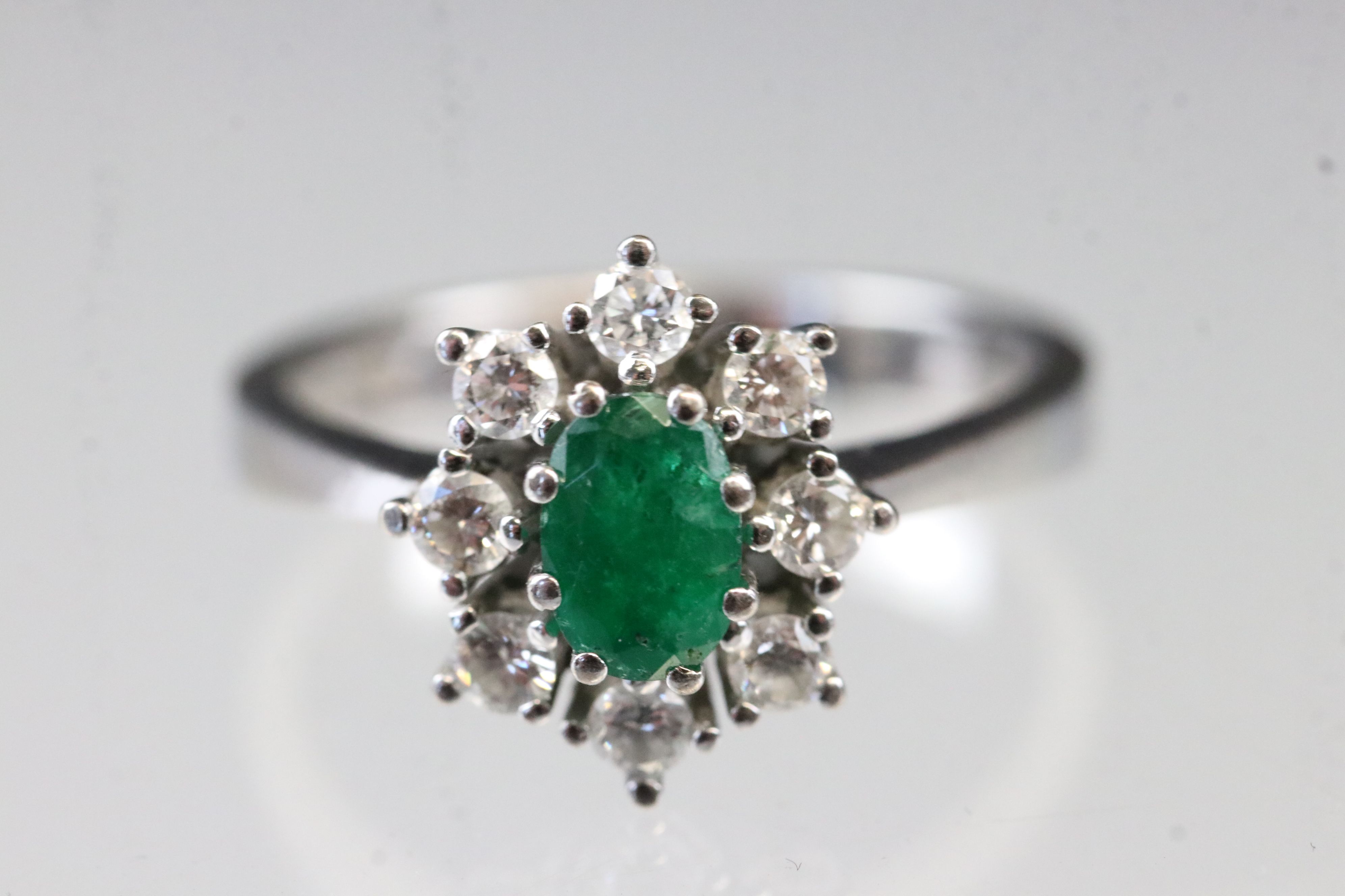 Emerald and diamond 18ct white gold cluster ring, oval mixed cut emerald, dimensions approx 6 x 4mm, - Image 2 of 5