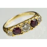 18ct gold diamond and garnet five stone ring. The ring being set with three brilliant cut diamonds