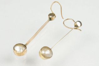 Pair of early 20th century grey mabe pearl yellow metal drop earrings, the grey mabe pearl with pink