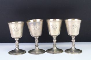 A set of four silver hallmarked goblets each having gilt interiors and raised on a knopped stem