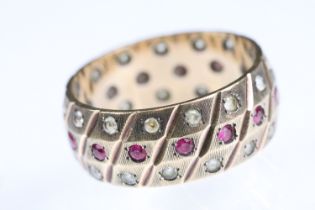 Synthetic ruby and white stone 9ct gold eternity ring, flush bead settings, textured band, width
