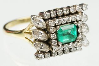 Emerald and diamond 18ct yellow and white gold cluster ring, the central emerald cut emerald