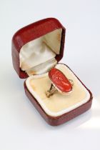 19th century coral 9ct gold ring, the carved coral modelled as a female head with hat, rubover