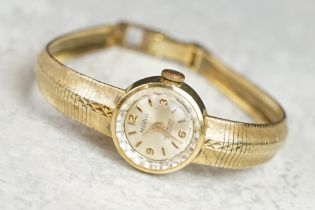 Monvis 14ct yellow gold ladies wristwatch, circular dial, Arabic and baton numeral markers, integral