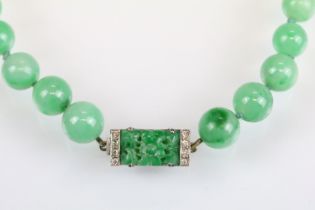 Art Deco jade and diamond necklace, sixty-six graduated round jade beads, the largest diameter