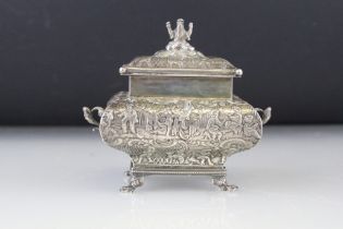 Dutch silver tea caddy, pagoda form, raised on four paw feet, twin scroll handles, the lid with cast