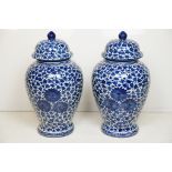 Pair of 20th century blue & white vases and covers, of baluster form, with floral and foliate