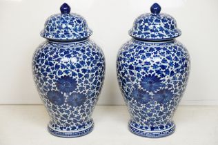 Pair of 20th century blue & white vases and covers, of baluster form, with floral and foliate