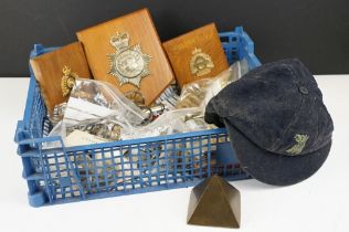 A box of mixed collectables to include military button, badges and patches, police helmet badge....