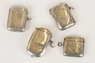 Three silver hallmarked vesta cases with engraved scrolling foliate decoration, together with a