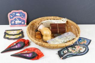 A group of oriental collectable within a wicker basket to include silk slippers, jade beads, cricket