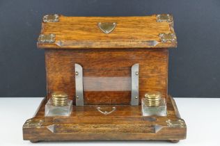 Late 19th / early 20th century oak double inkwell desk stand with letter box, the glass inkwells