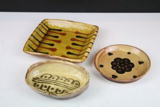 Three pieces of 20th Century silp ware pottery to include an oval dish (monogrammed PG), round