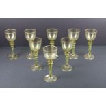 Set of eight green glass Roemer style wine glasses having twist stems and gilt rims. Measures 18cm