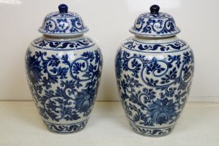 Pair of 20th century Chinese style blue and white vases & covers, of ovoid form, with underglaze