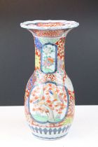 Chinese 19th Century vase having a flared rim, with blue underglazed details over glazed with red