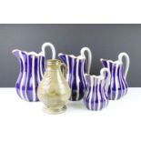 Set of four graduating pottery jugs with gilt, blue & white striped design (tallest approx 22.