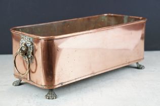 Copper planter of rectangular form, with rolled upper rim, twin lion mask loop handles, raised