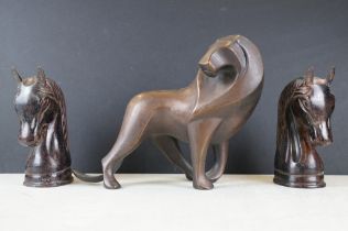 Cast bronze figure of a stylised lion, together with a pair of spelter horse head bookends (approx