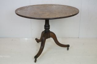 Regency Mahogany Circular Tilt-Top Table raised on a pillar support with three out-swept legs