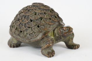 An oriental cast metal incense burner in the form of a tortoise.