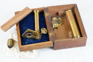 An antique wooden cased brass students microscope.