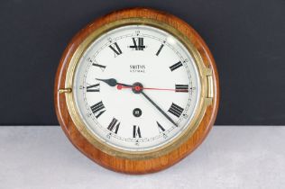 Smiths Astral brass bulkhead nautical ships clock, with bevelled glass front, the cream dial with